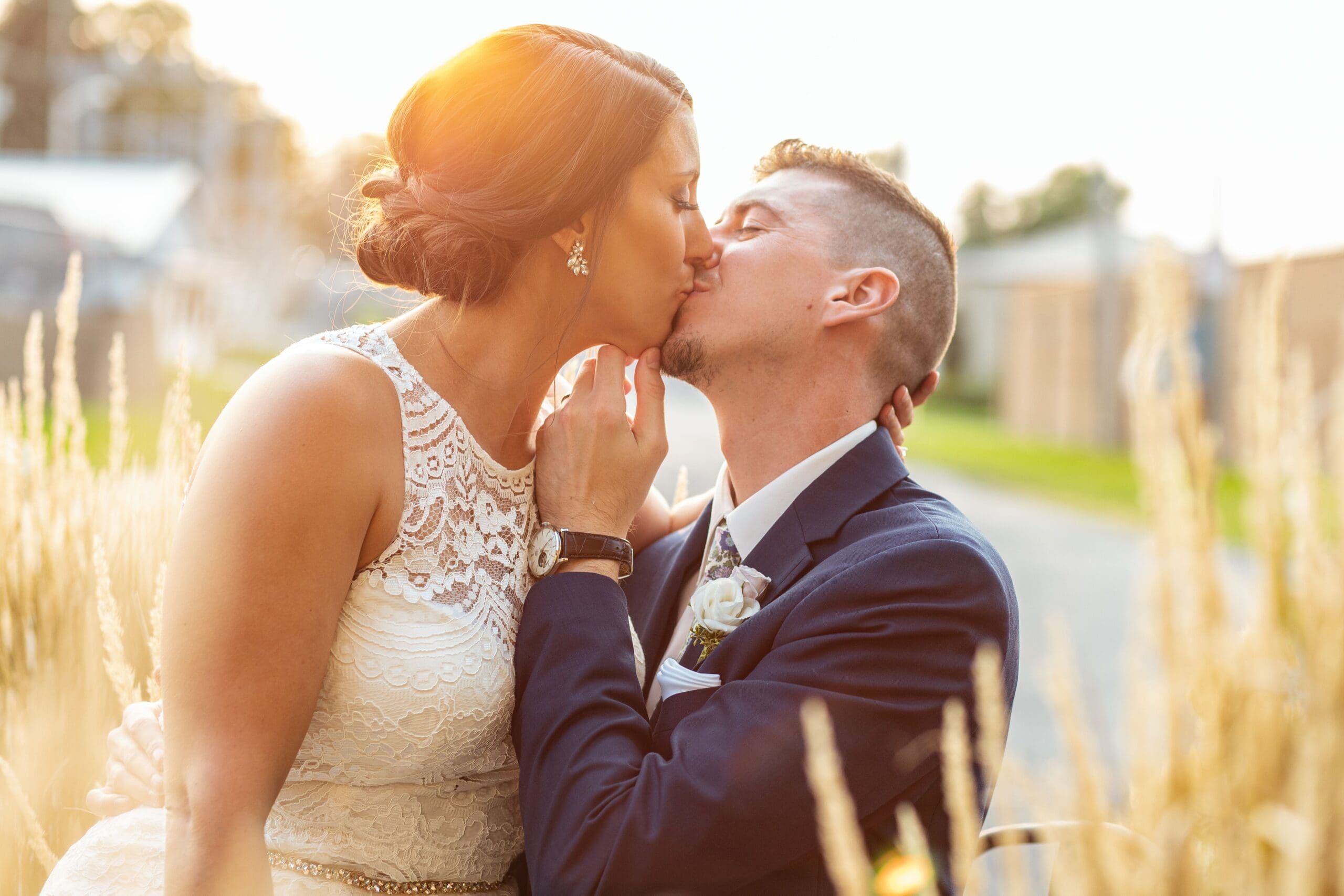 sunset kiss, wedding day, bride and groom, navy, lace wedding dress, diamond earrings, wedding bun, southern illinois photographer