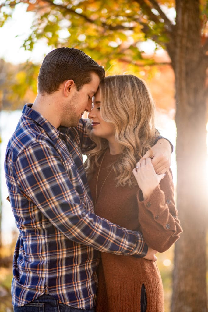 embracing couple, fall engagement session, warm autumn session