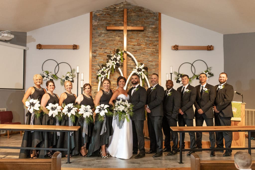 bridal wedding party, black and white wedding, classy and elegant wedding, black bridesmaids dresses, black tuxedos, black and white floral arrangements, black and white bridal bouquets