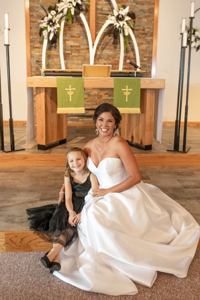 bride with family, bride with flower girl, Lutheran church, Lutheran wedding, bride at altar, bride smiling with family