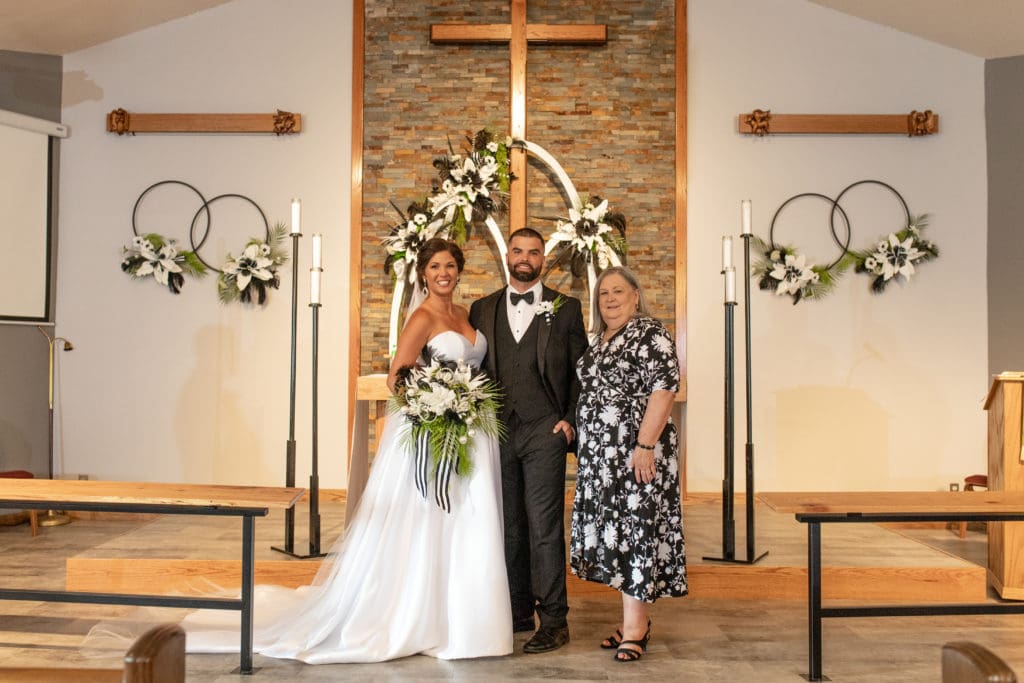 groom and bride with grooms mom, family wedding picture, black and white bouquet