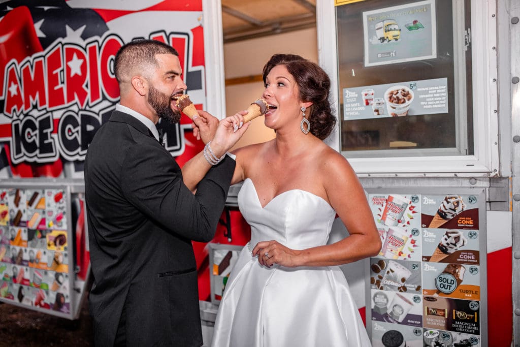 bride and groom eating ice cream, wedding ice cream dessert, ice cream food truck, bride and groom feeding each other