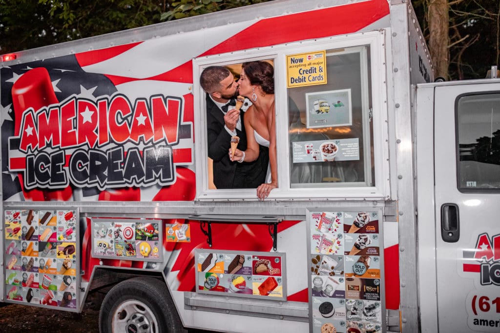 bride and groom kissing in ice cream food truck, food truck outdoor wedding