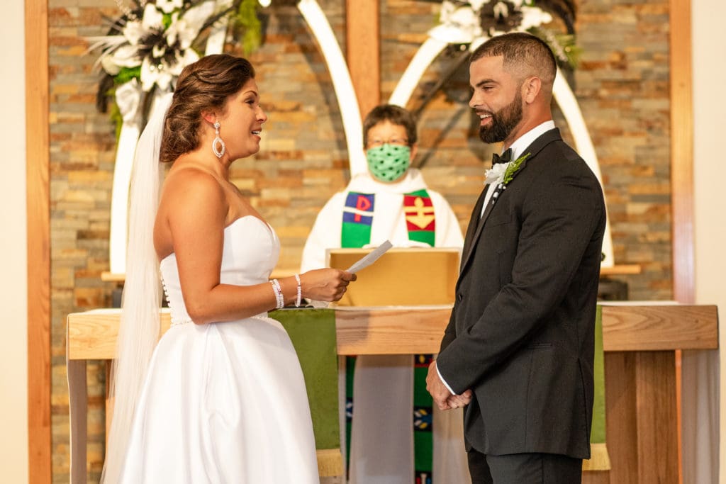 bride and groom at altar, bride and groom say i do, Lutheran wedding, Lutheran church, exchanging rings
